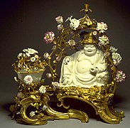 Scent container featuring a Chinese porcelain figure of Budai with French ormolu gilding and added porcelain flowers, an example of chinoiserie art. France, 1745–1749.