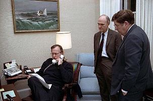 George H. W. Bush speaks into a telephone in the Oval Office Study