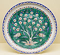 Dish with a prunus tree reserved in white on a green ground, c. 1585