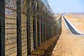 Image 10A more recent section of the Israel-Egypt barrier fence, north of Eilat, June 2012. It is a border barrier built by Israel along its border with Egypt. It was originally an attempt to curb illegal migrants from African countries.[1] Construction was approved on 12 January 2010[2] and began on 22 November 2010.[3]