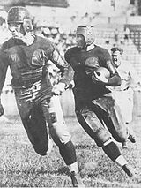 A player running in front of the ball-carrier