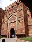 Decorated gate to a fortress of red stone.