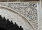 Arabesques carved in stucco over an archway in the al-Attarine Madrasa in Fes (14th century)