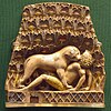 A piece of ivory showing a lion devouring a man