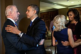 The Obamas and the Bidens embrace following the television announcement of their victory.