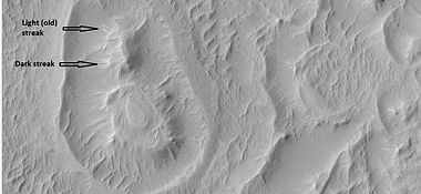 Close-up of circular structure from previous image, as seen by HiRISE under HiWish program Streaks are also visible.