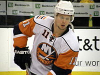 Andy Hilbert on the ice looking down.