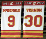 Two rectangular banners, both white with red and yellow trim at the top and bottom. The left one says "1981 – 1989 McDONALD 9" and the right "1982 – 2002 VERNON 30"