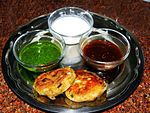 Aloo tikki served with mint and tamarind sauce and yogurt