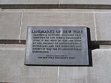 A plaque on the facade that describes the building's history