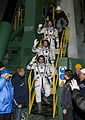 The TMA-12M crew members wave to spectators before launch.