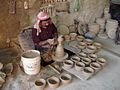 Image 49An artisan making pottery using the traditional mud and water mixture on a revolving wheel. (from Bahrain)