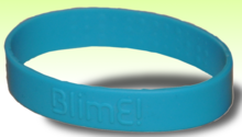 a blue silicone reversible bracelet with the word "BlimE!" embossed onto the outside, with the E being written backwards as this is the way it appears in the BlimE! logo.