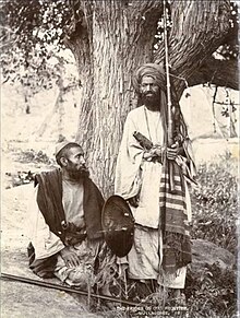 Mullagori tribesmen depicted in 1880, showcasing their traditional attire and weaponry