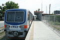 Northbound platform of Sucat railway station with a parked PNR diesel multiple unit