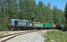 A colour photograph of a train with open cars carrying oil shale near Ahtme, dated to June 2007. The locomotive is on the left.