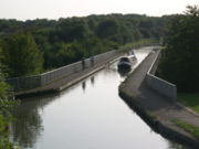 The Grand Union Canal passes over Grafton Street at New Bradwell via the modern New Bradwell Aqueduct.