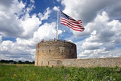 The round tower at Fort Snelling with US flag.