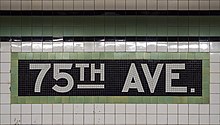 White and green tile mosaic spelling out the station name
