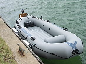 Inflatable boat with small electric trolling outboard motor