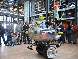 The Muppet Mobile Lab at the Pixar Studios, featuring two Muppets, Honeydew and Beaker. Pete Docter, Pixar's chief creative officer, can be seen above the vehicle's headlights.
