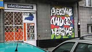 Graffiti as legal advertising on a grocer's shop window in Warsaw, Poland