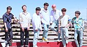 BTS posing for the camera while outdoors