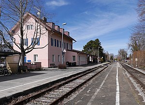 Two-story stucco building next to railway line