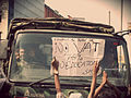 Students protests against the imposition of vat in their tuition fees by upholding the placard in front of Army vehicle.