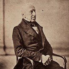 Seated photographic half-length portrait on a chair of Sir Charles Monck