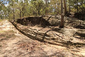 Convict-built road, Mount McQuoid, Great North Road, Bucketty, NSW. Gutter cut in stone.