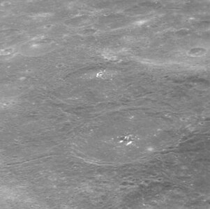 Oblique view of Lu Hsun crater (lower right), with bright hollows at the central peak