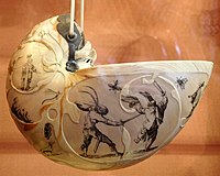 Nautilus shell carved and painted with fanciful scenes of human figures and animals (spider, dragonfly, dog, butterfly, sawfly, fly), bronze pendant mount, nineteenth century. Poldi Pezzoli Museum, Milan