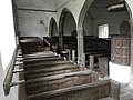 The interior of St Petrock's from the front of the south aisle. Note the hat pegs on the wall on the left