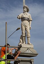 a statue being lifted