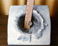 A 7-gram object (shown in centre) shot at 7 km/s (23,000 ft/s), the orbital velocity of the ISS, made this 15 cm (5.9 in) crater in a solid block of aluminium