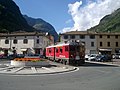 A Berninabahn train crossing the main square in Tirano