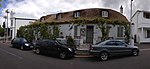 Single storey semi-detached vernacular building; half hipped thatched fanlight to Idoville and glazed Victorian door to Durban House; raised stoep with a low plastered wall and plastered brick columns supporting a timber pergola; Original outbuildings Type of site: House Current use: House.