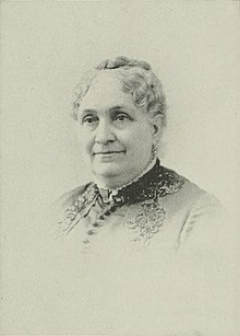 Sepia-colored photograph of a middle-aged white woman.