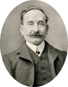 Portrait photograph of Fernando Tarrida, wearing a suit and a moustache, with receding hair