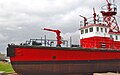 Photograph of Fireboat No. 1 in drydock as a museum ship. Several water cannons stand prominently at the bow, atop the bridge, and in the crow's nest.