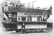 Side view of one of the new trams in 1903 including the livery, truck and track brake. Note the luxury of lower saloon curtaining.