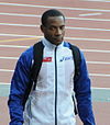 image of Tyone Smith from 2012, wearing a white uniform with blue long sleeves and a dark zipper down the front center