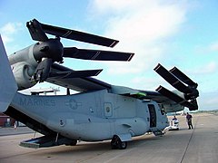 A V-22 Osprey with wings rotated parallel to fuselage