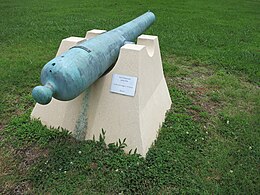 Photo shows a 14-pounder James Rifle mounted on a concrete pedestal.