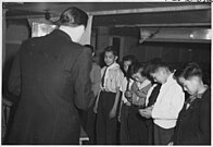 Boy Scouts hold court of Honor at Central Utah Relocation Center at Topaz. Deputy Director, James F. Hughes, presents merit badges to first class scouts.