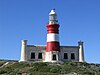 Photo of Cape Agulhas Lighthouse with tower painted in horizontal red and white bands