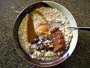 Porridge made from 1-minute quick-cooking rolled oats with raisins, peanut butter, honey, and cinnamon.