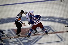 Photograph of Hayes waiting for the referee to drop the puck for a faceoff