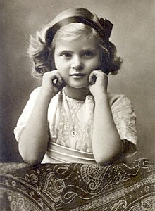 Black-and-white photo of Theodora in 1910, showing her face and arms, with a ribbon in her hair.